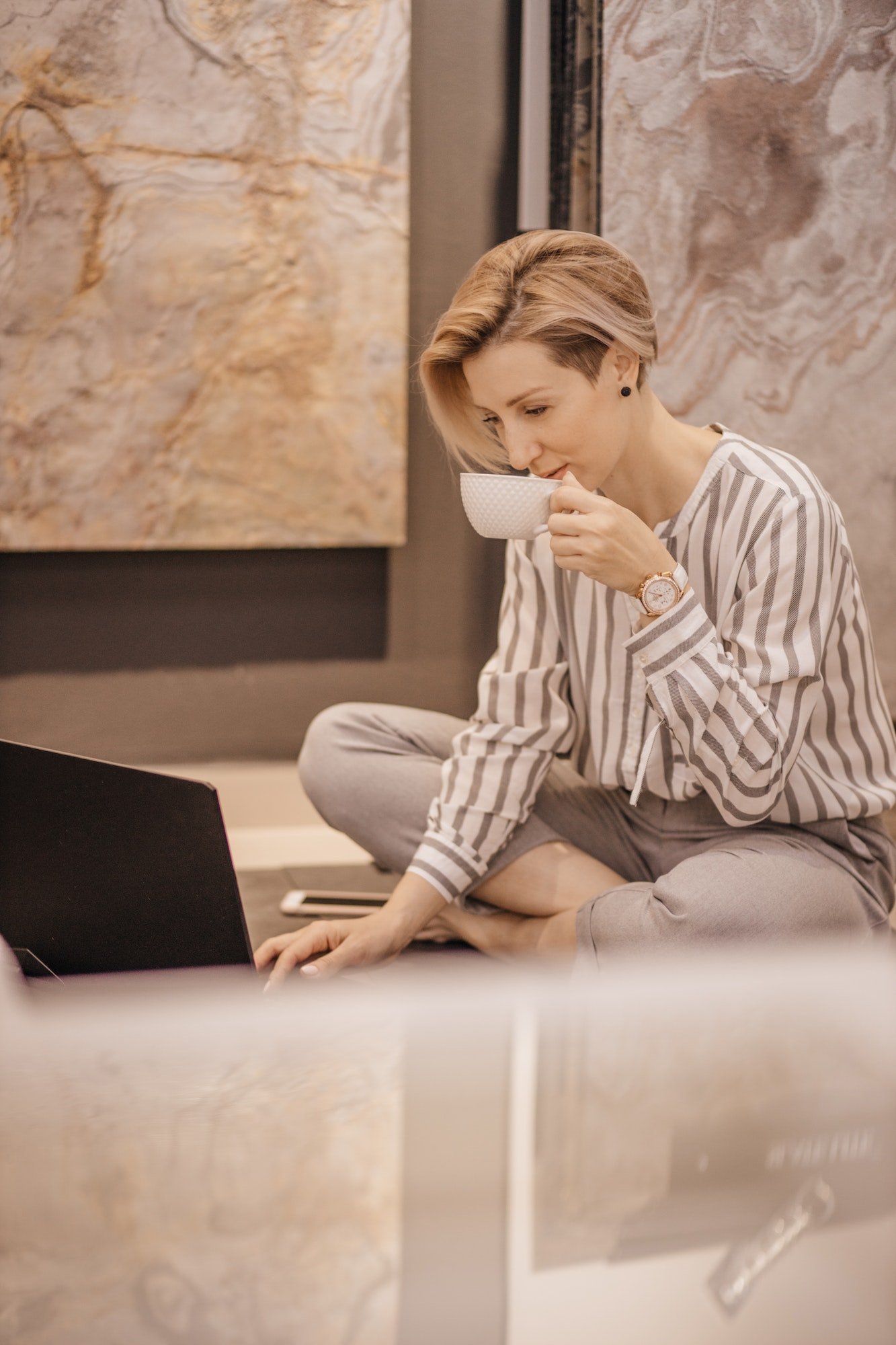 The designer girl works on a laptop computer